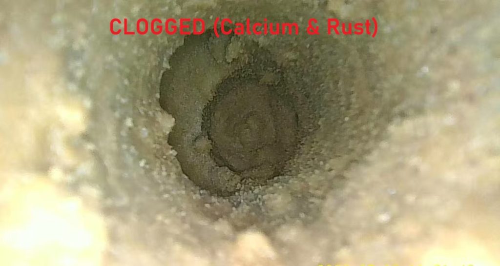 Borescope inspection showing severe calcium scale and rust clog inside injection mold cooling channel